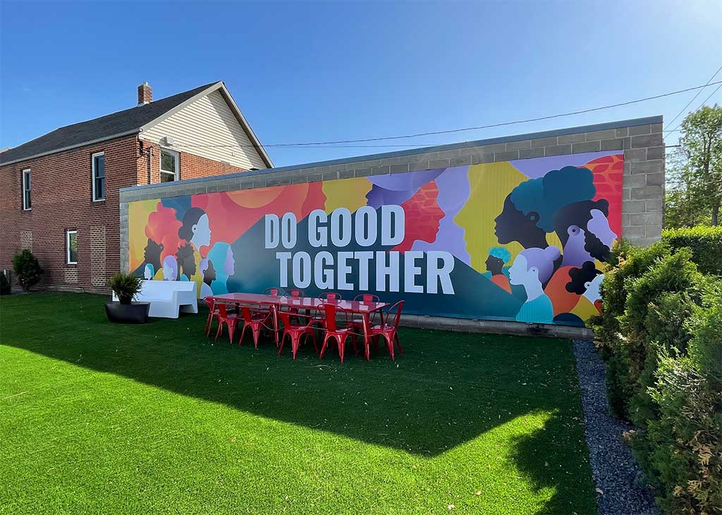Do Good Together large canvas sign on brick wall Do Good Together large canvas sign on brick wall